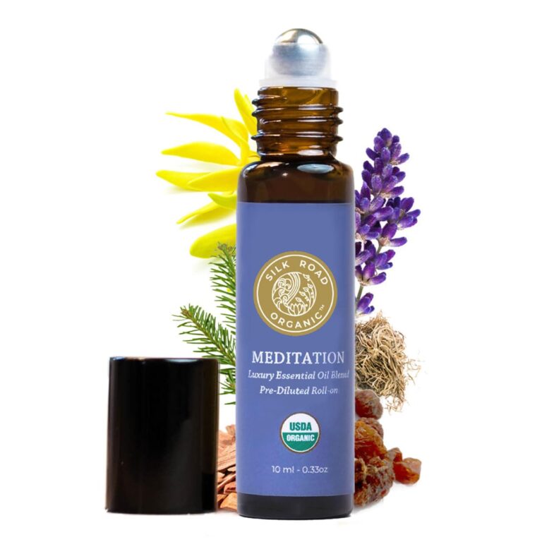 Meditation essential oil roll-on bottle with flowers and herbs on white background