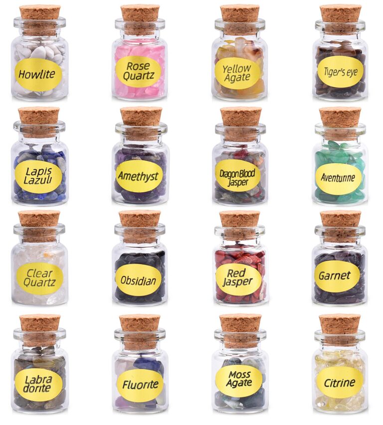 Sixteen small glass jars with cork stoppers, each filled with different gemstones